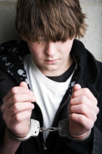 teen crime – kid in handcuffs